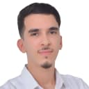 Youssef Aserrar, smiling, arms crossed, in a white shirt.